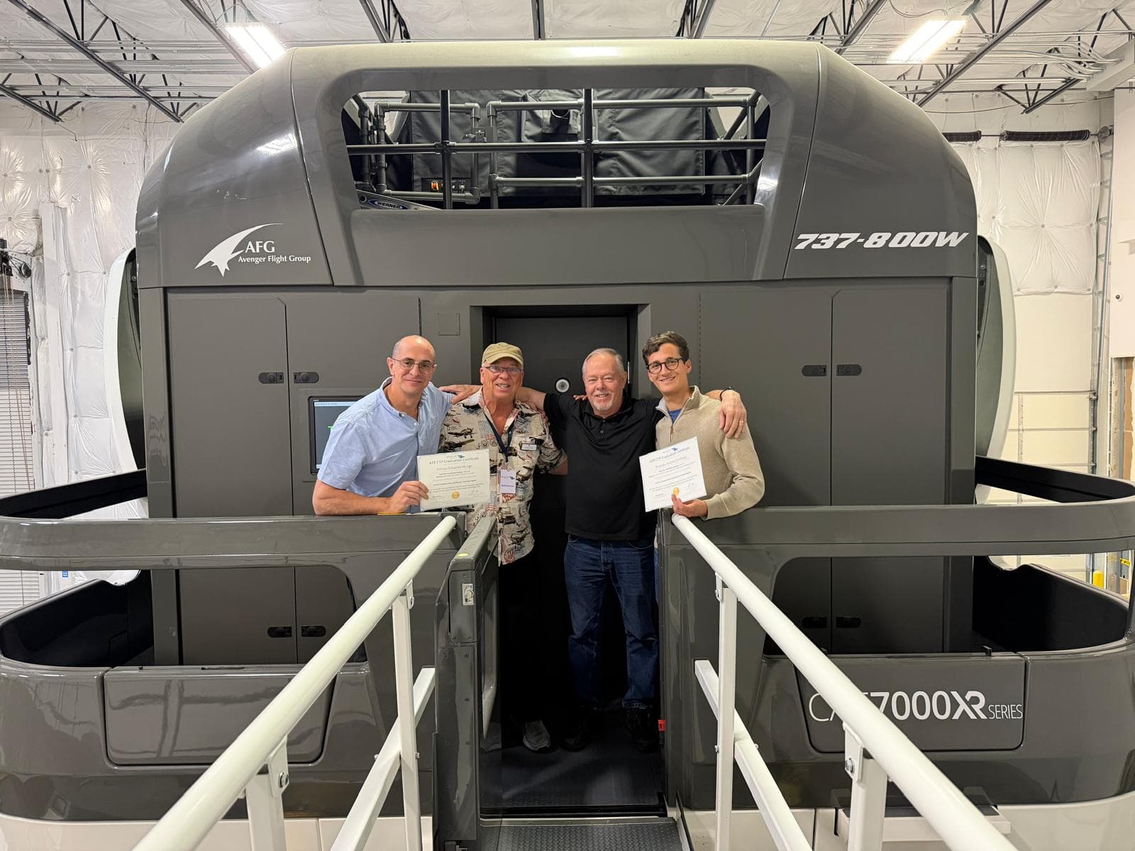 AVS graduates and instructors in front of the B737-800W simulator